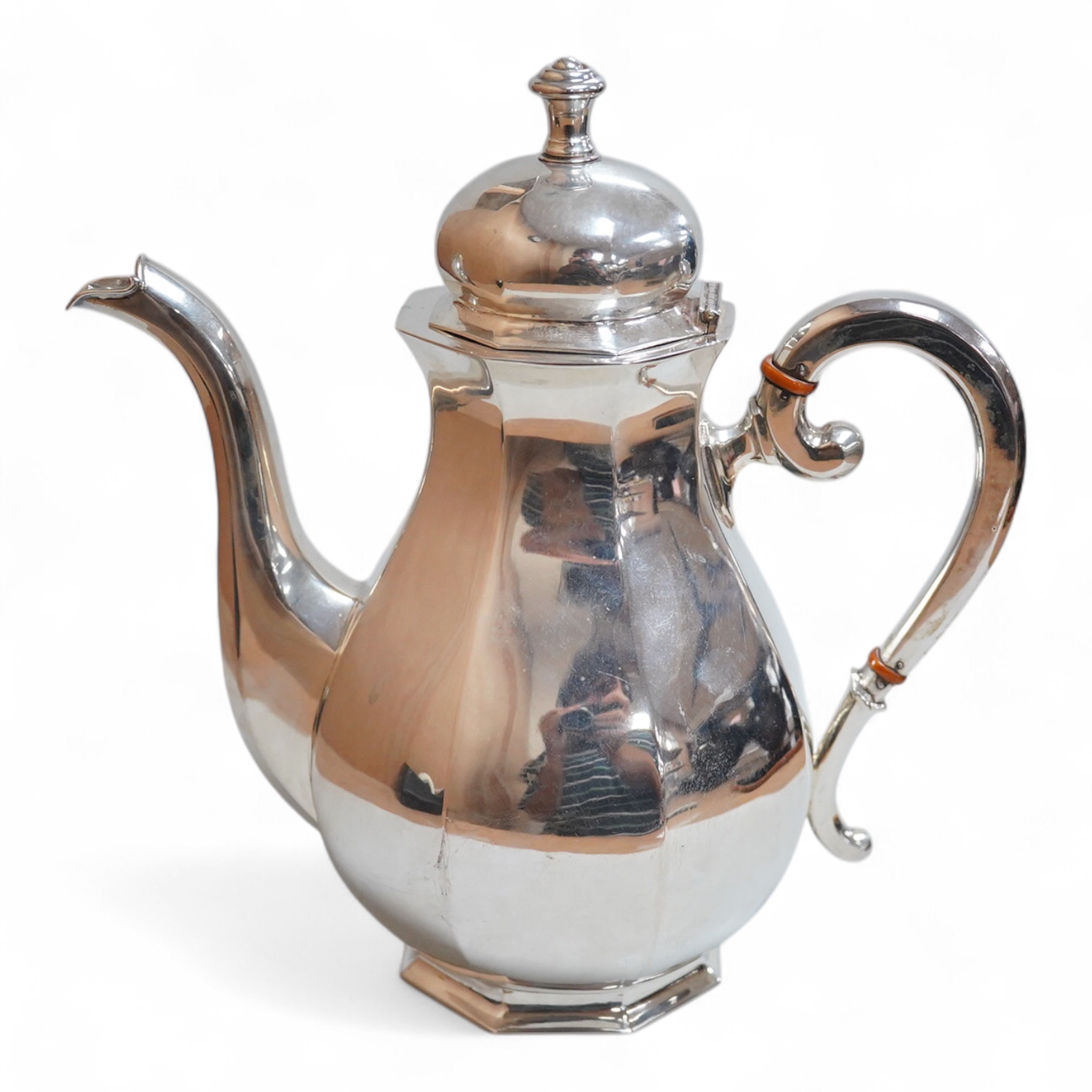 A white metal octagonal coffee pot with hinged cover, (tests as a low grade silver), on octagonal foot, height 23cm, gross weight 21oz.